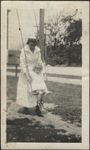 Nurse with Young Girl on Swing